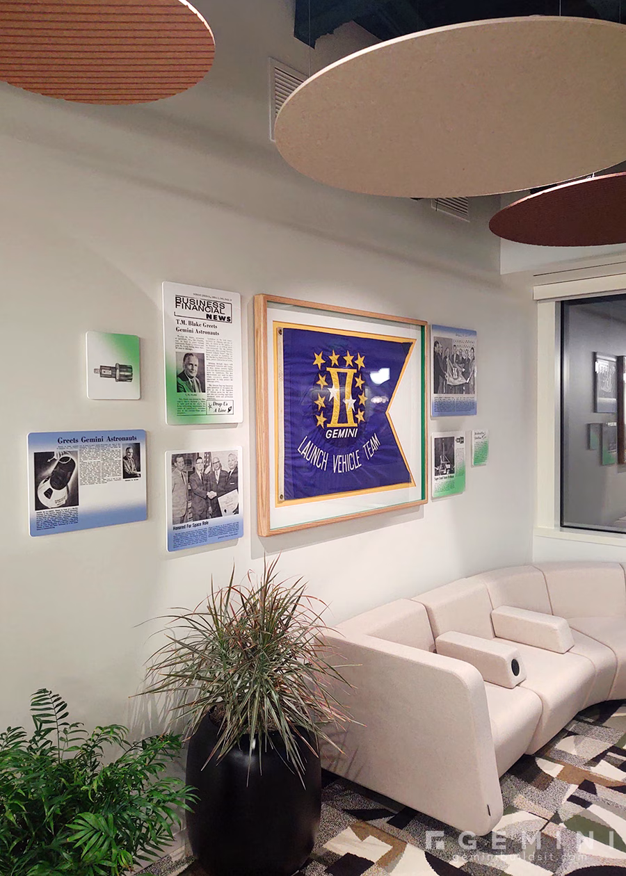 Angled view of the Littelfuse corporate history wall featuring its framed Gemini flag and restored Space Race archives.